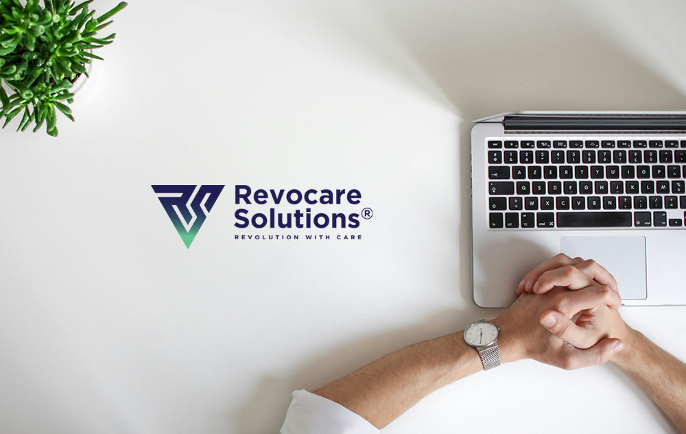  Revocare Solutions BPO company logo design — gradient RS triangle icon and wordmark on a white desk with laptop and plant